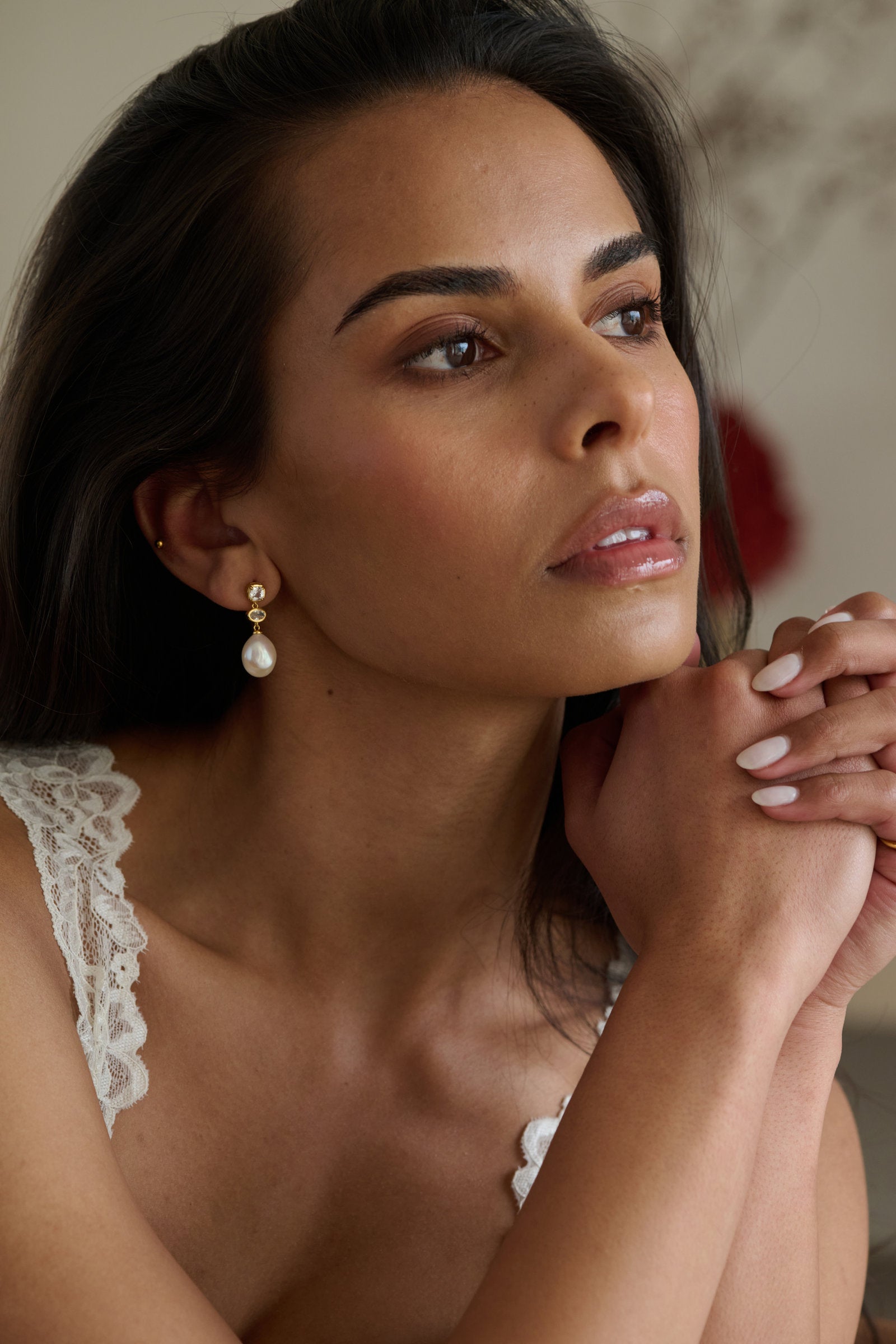 Sapphire Pearl Drop Earring in gold, worn, showing the cushion sapphire, east-west oval and baroque pearl